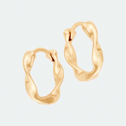 The Undae Mini hoop earring by Ocarina, an 18K gold-plated design with a fluid, organic shape inspired by natural waves. A minimalist yet bold statement piece, displayed against a clean white background